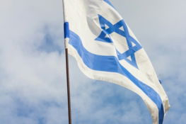 blue and white flag under cloudy sky during daytime